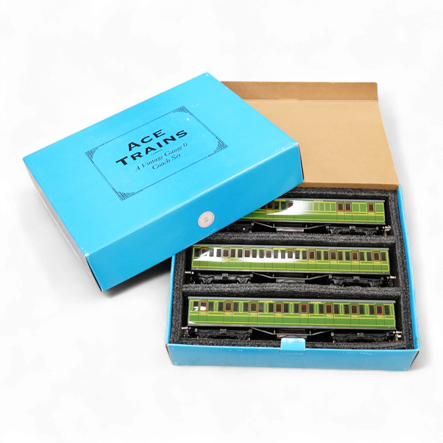 A boxed ACE Trains 0 gauge tinplate coach set; C/1 SR, comprising of three Southern Railway bogie coaches; a Full First, a Full Third and a Brake Third